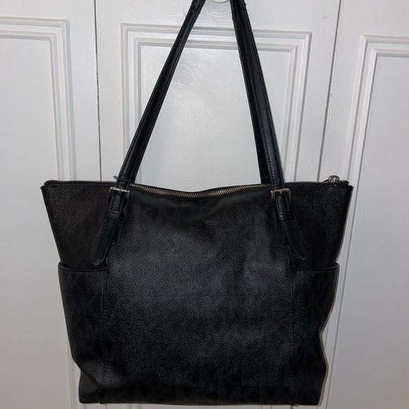 Black Michaels Kors tote handbag with pockets on the sides. - Picture 2 of 6